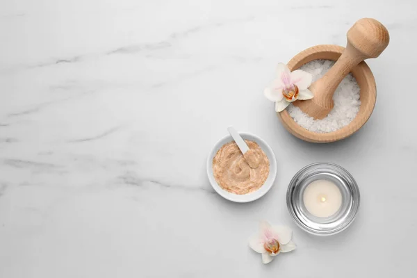 stock image Flat lay composition with different spa products and flowers on white marble table. Space for text