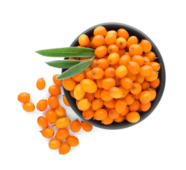 stock image Bowl with fresh ripe sea buckthorn berries and green leaves on white background, top view