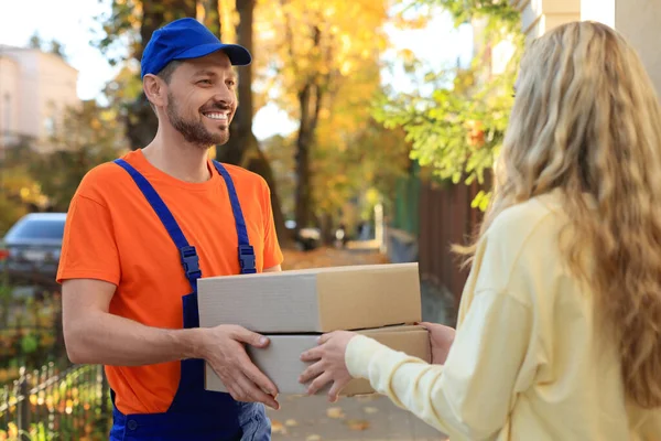 Woman Receiving Parcels Courier Uniform Outdoors — Fotografia de Stock