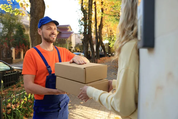 Woman Receiving Parcels Courier Uniform Outdoors — Fotografia de Stock