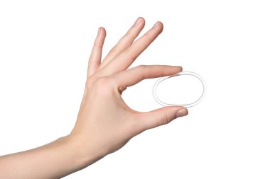 Woman holding diaphragm vaginal contraceptive ring on white background, closeup