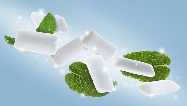 Fresh mint leaves and chewing gum pads falling around lights on light blue background