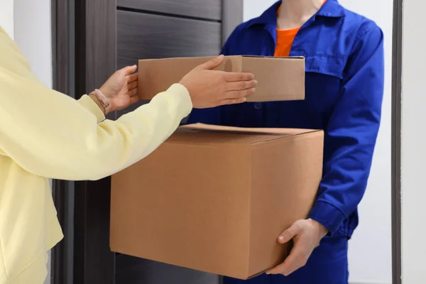 Courier Giving Parcels Woman Indoors Closeup — Stock Photo, Image