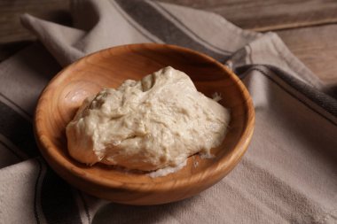 Fresh dough on wooden table, closeup. Cooking grissini
