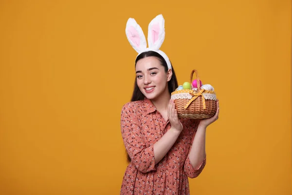 Happy Woman Bunny Ears Headband Holding Wicker Basket Painted Easter — 图库照片