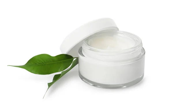 stock image Face cream in glass jar and leaves on white background