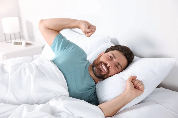 Happy Man Stretching Comfortable Pillow Bed Home — Fotografie, imagine de stoc