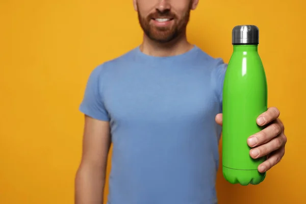 Hombre Con Termo Botella Verde Sobre Fondo Naranja Primer Plano —  Fotos de Stock