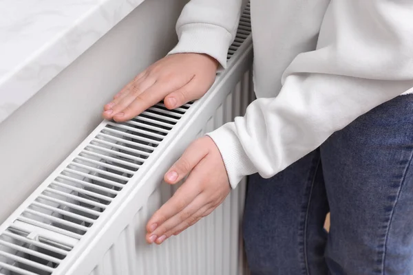 Girl Warming Hands Heating Radiator Indoors Closeup — Stok fotoğraf