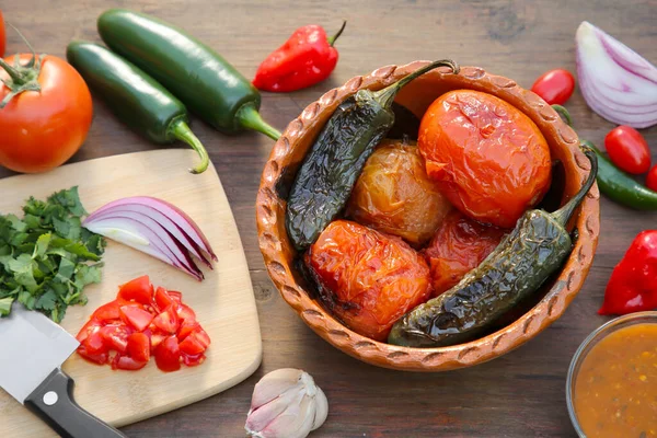 Tasty salsa sauce and ingredients on wooden table, flat lay