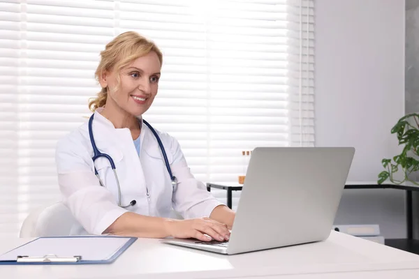 Läkare Med Laptop Och Urklipp Vid Vitt Bord Kliniken Patientsamråd — Stockfoto