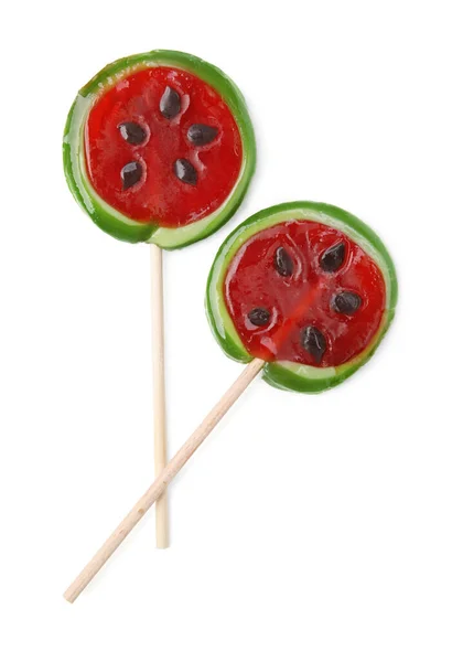 Watermelon shaped lollipops on sticks against white background, top view