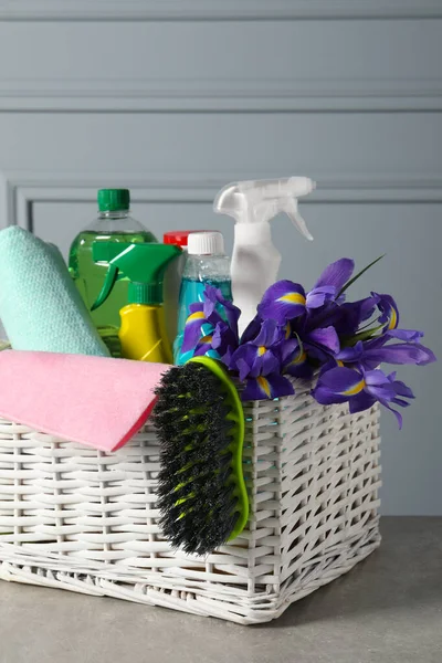 Spring Cleaning Basket Detergents Flowers Tools Grey Textured Table — Zdjęcie stockowe
