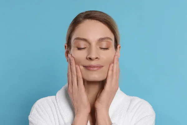 Woman Massaging Her Face Turquoise Background — 스톡 사진