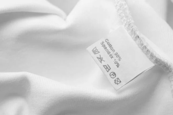 stock image Clothing label with care recommendations on white garment, closeup. Space for text