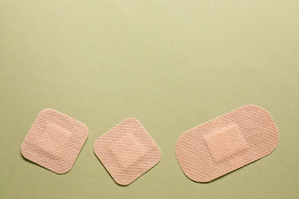 stock image Different contraceptive patches on green background, flat lay. Space for text