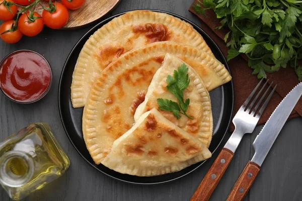 Delicious Fried Chebureki Cheese Parsley Ingredients Served Grey Wooden Table — Stock Photo, Image