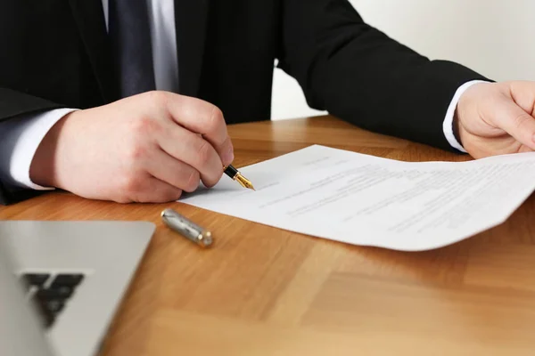 stock image Notary signing document at wooden table, closeup