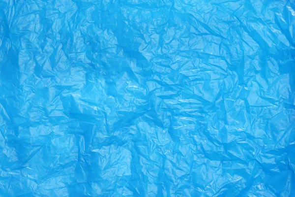 stock image Crumpled light blue plastic bag as background, top view