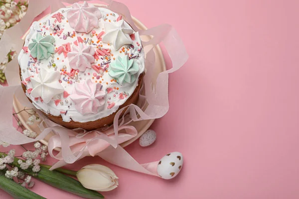 stock image Traditional Easter cake with meringues and painted eggs on pink background, above view. Space for text