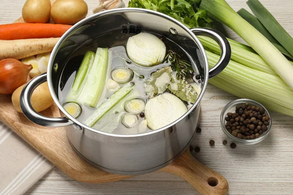 Pot Different Ingredients Cooking Tasty Bouillon White Wooden Table — Stock Photo, Image