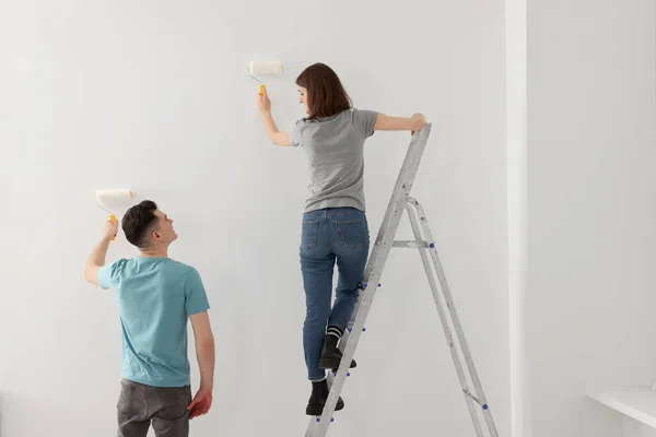 Νεαρός Άντρας Και Γυναίκα Ζωγραφίζουν Τοίχους Ρολά Εσωτερικούς Χώρους Ανακαίνιση — Φωτογραφία Αρχείου