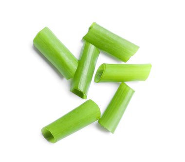 Pieces of fresh green onion on white background, top view