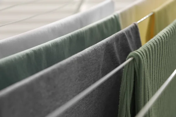Different apparel drying on clothes airer, closeup