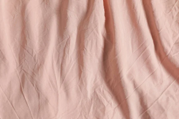 stock image Crumpled pink fabric as background, top view