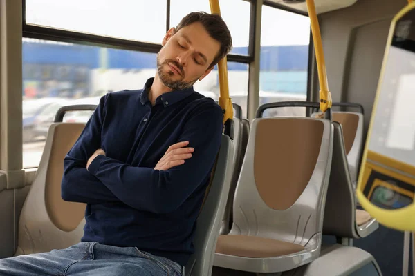 stock image Tired man sleeping while sitting in public transport