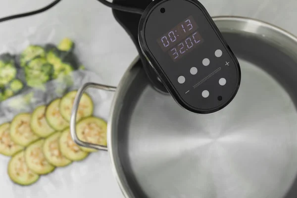 stock image Sous vide cooker in pot on white table, closeup. Thermal immersion circulator