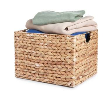 Wicker laundry basket with clean clothes isolated on white