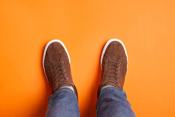 Man Stylish Sneakers Standing Orange Background Top View — Stock Photo, Image