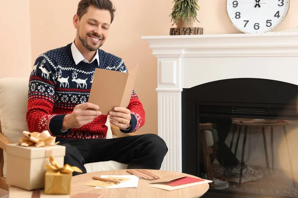 Happy Man Czytanie Kartki Świąteczne Salonie — Zdjęcie stockowe