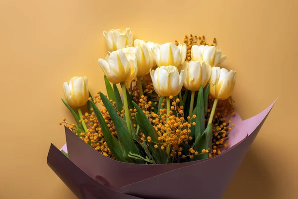 stock image Bouquet with beautiful tulips and mimosa flowers on yellow background, top view