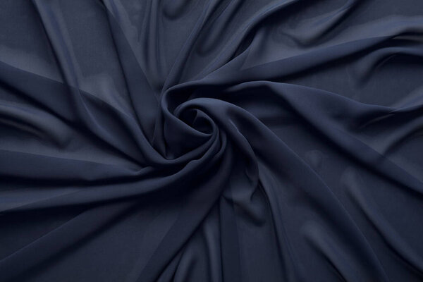Beautiful dark blue tulle fabric as background, top view