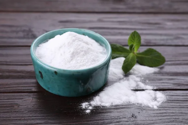 stock image Sweet fructose powder and mint leaves on dark wooden table