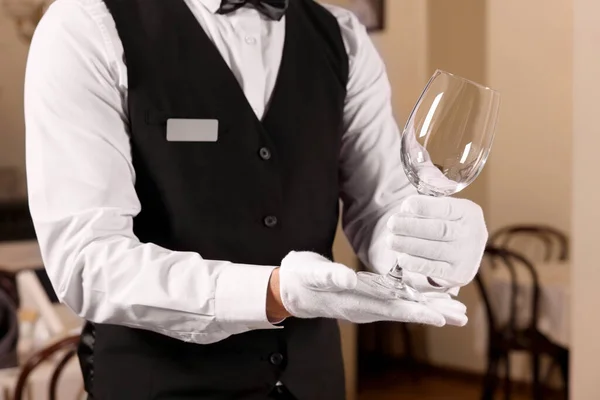 Stock image Man setting table in restaurant, closeup. Professional butler courses