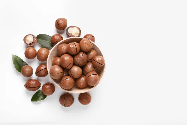 stock image Delicious organic Macadamia nuts on white background, flat lay. Space for text