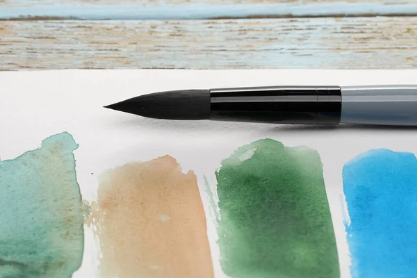 Sheet Paper Watercolor Strokes Brush Light Grey Wooden Table Closeup — Stock Photo, Image