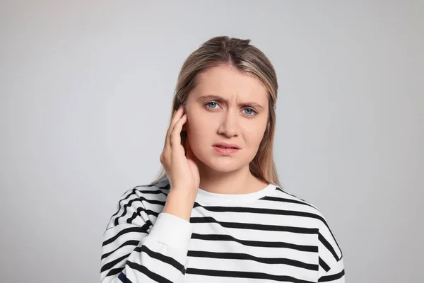Young Woman Suffering Ear Pain Light Grey Background — Stockfoto