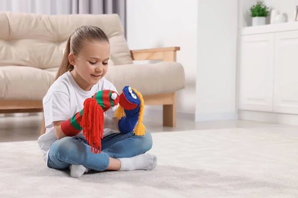 Happy daughter with funny sock puppets playing at home, space for text