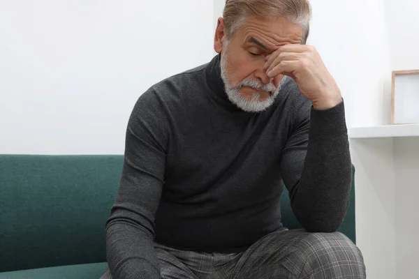 stock image Upset senior man on sofa at home. Loneliness concept