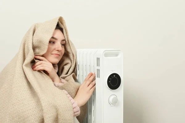 Young Woman Warming Herself Modern Electric Heater Indoors — Stock Photo, Image