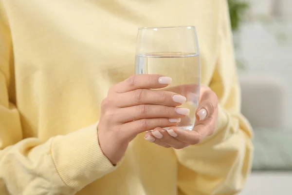 Healthy habit. Woman holding glass with fresh water indoors, closeup