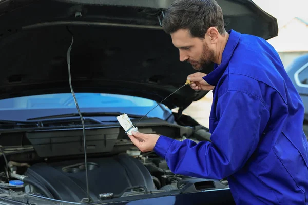 Worker Checking Motor Oil Level Dipstick Outdoors — Stockfoto