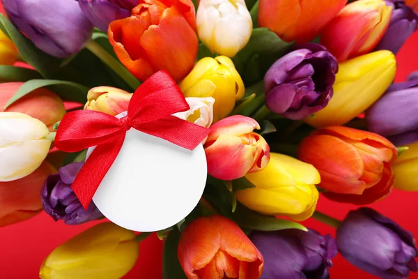 Букет Красивих Різнокольорових Тюльпанів Порожньою Карткою Червоному Тлі Крупним Планом — стокове фото