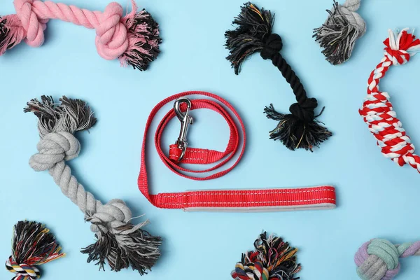 stock image Flat lay composition with dog leash and toys on light blue background