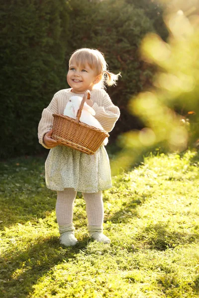 Happy Little Girl Holding Wicker Basket Cute Rabbit Outdoors Sunny — Stockfoto