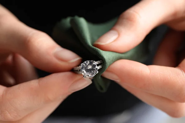 stock image Jeweler cleaning diamond ring with microfiber cloth, closeup